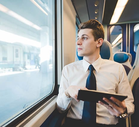 portrait of young businessman commuter using laptop