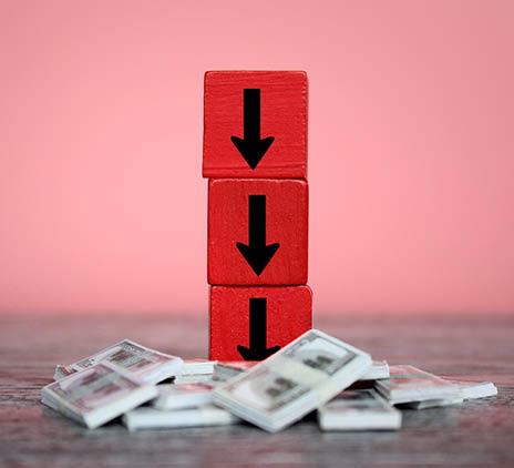 Stacks of cash with red blocks and black arrows