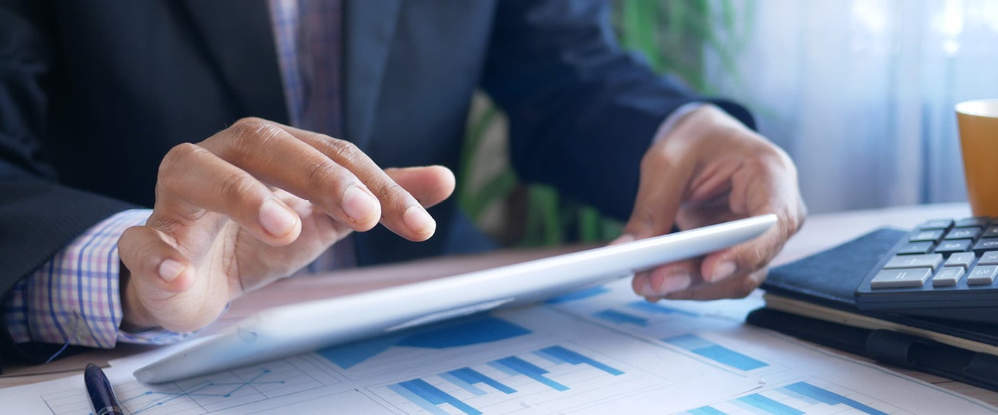 businessman using digital tablet on office desk