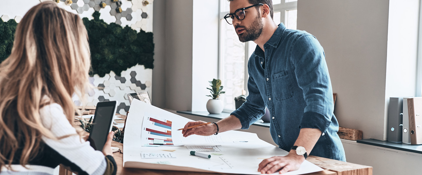 Man and woman discussing strategy in an office