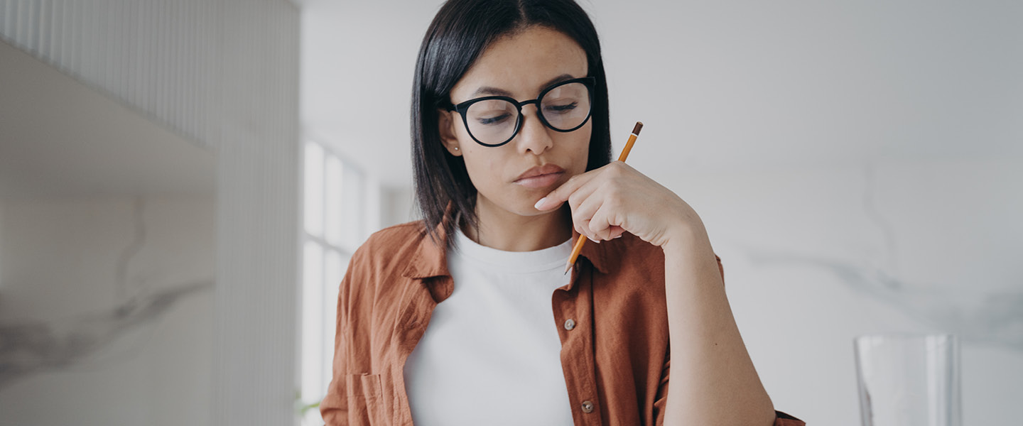 woman with glasses calculating expenses