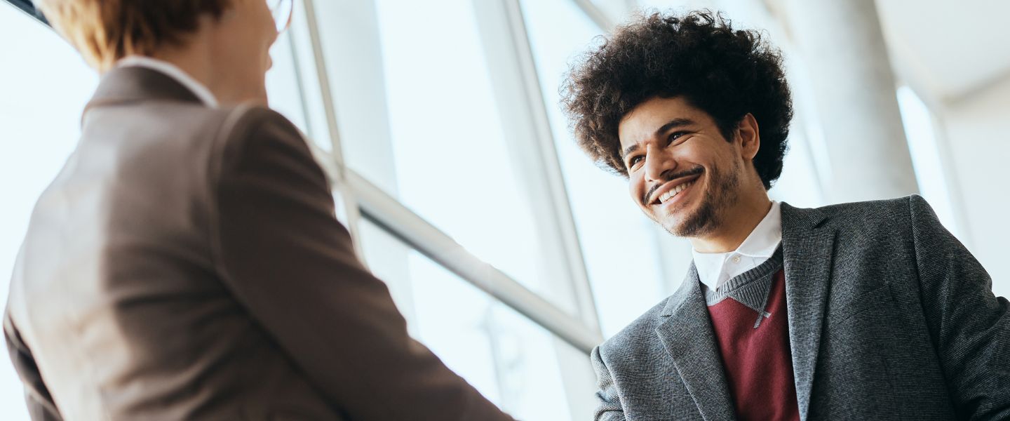 happy businessman shaking hands with woman