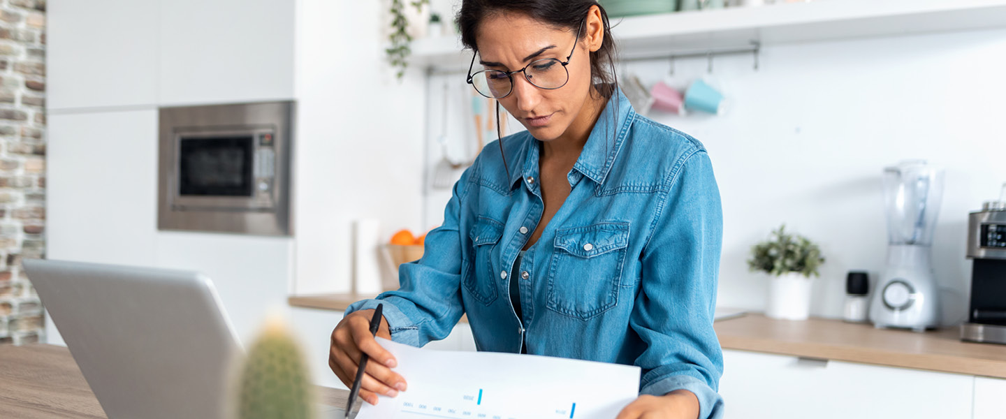 pretty young woman reviewing paperwork and working