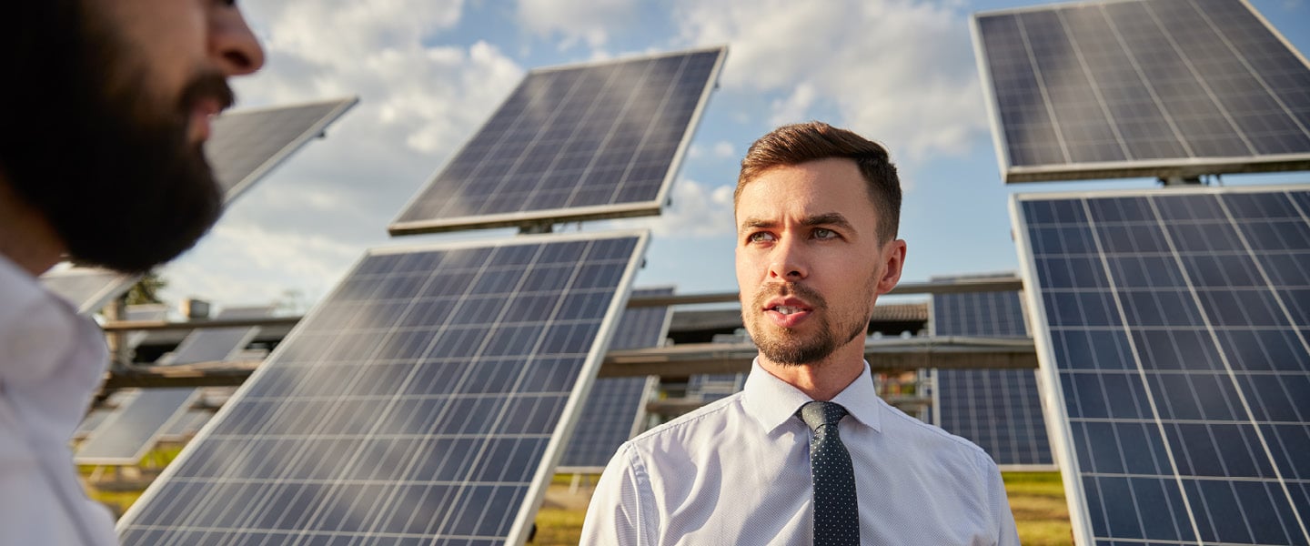 man in front of solar panels