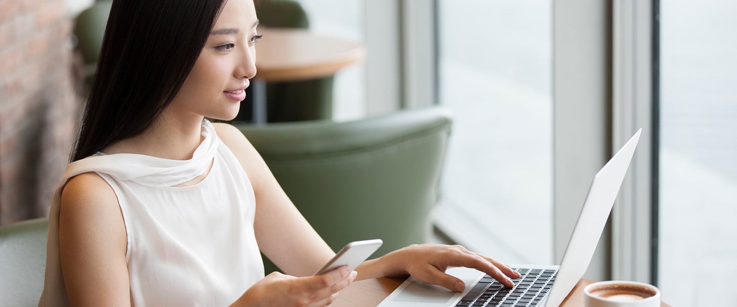 young woman working with laptop in cafe