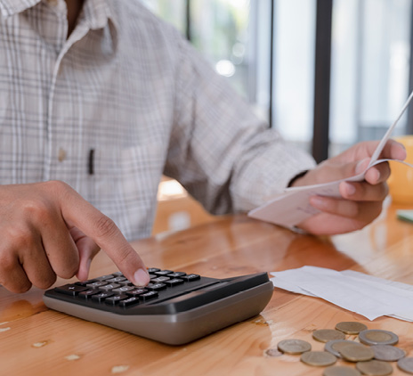 accountant calculating bill with coins in background