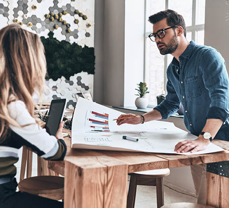 Man and woman discussing strategy in an office