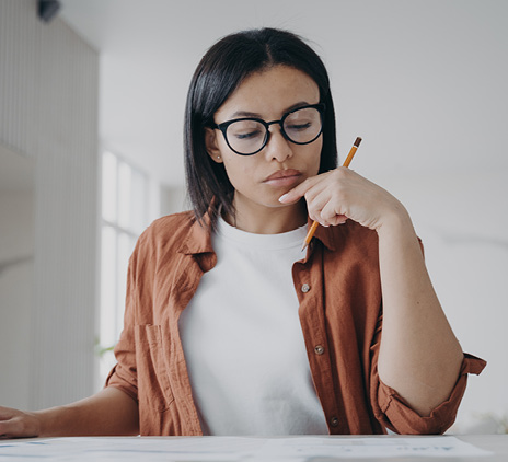 woman with glasses calculating expenses