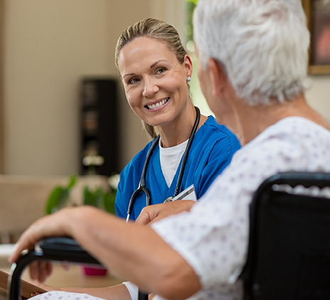 Friendly nurse talking to senior patient