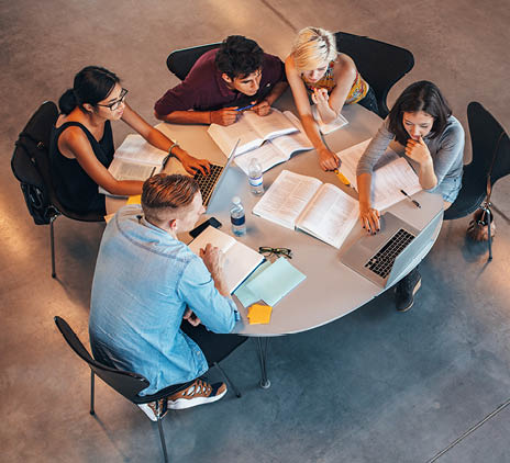 group of students studying on laptop