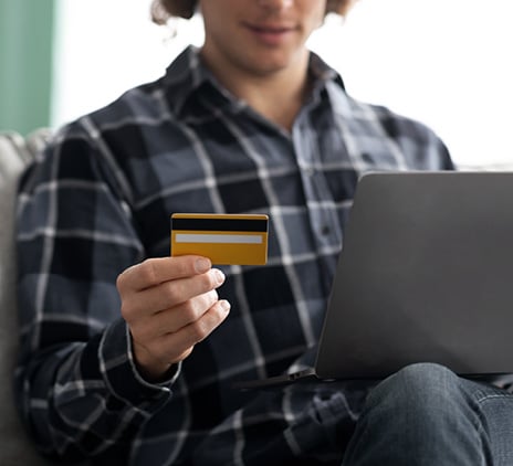 guy using laptop and creditcard shopping online