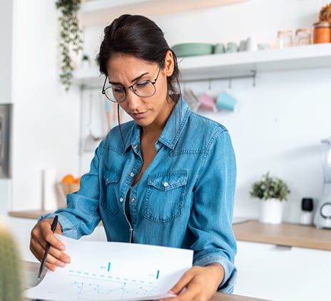 pretty young woman reviewing paperwork and working