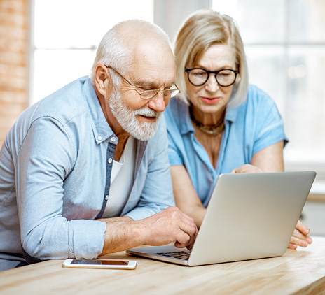 Older man and women behind laptop