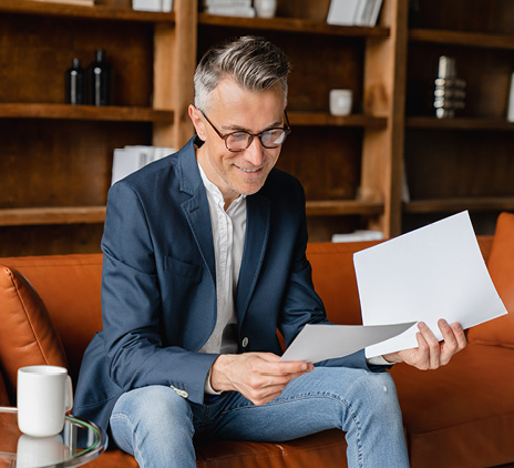 mature businessman holding papers in an office