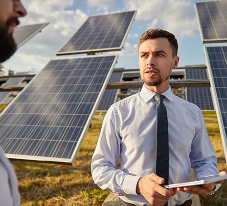 man in front of solar panels