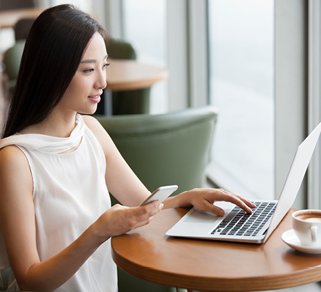 young woman working with laptop in cafe