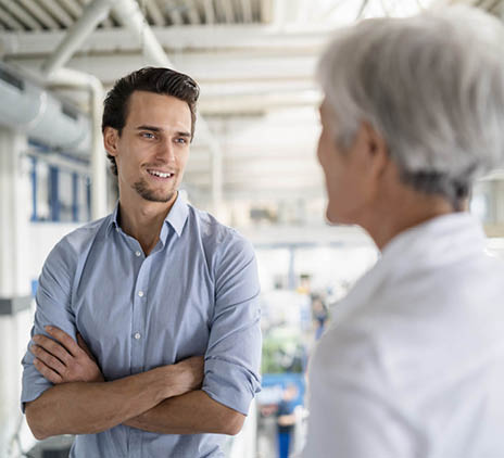 smiling businessman talking to senior businesswoman