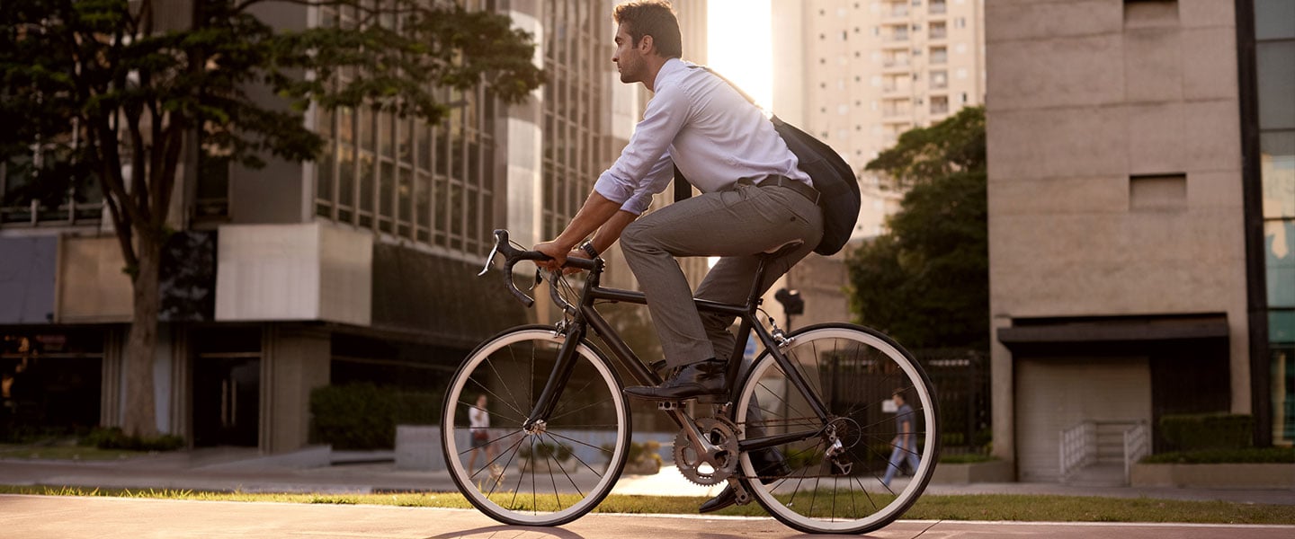 A man in business wear riding a bike