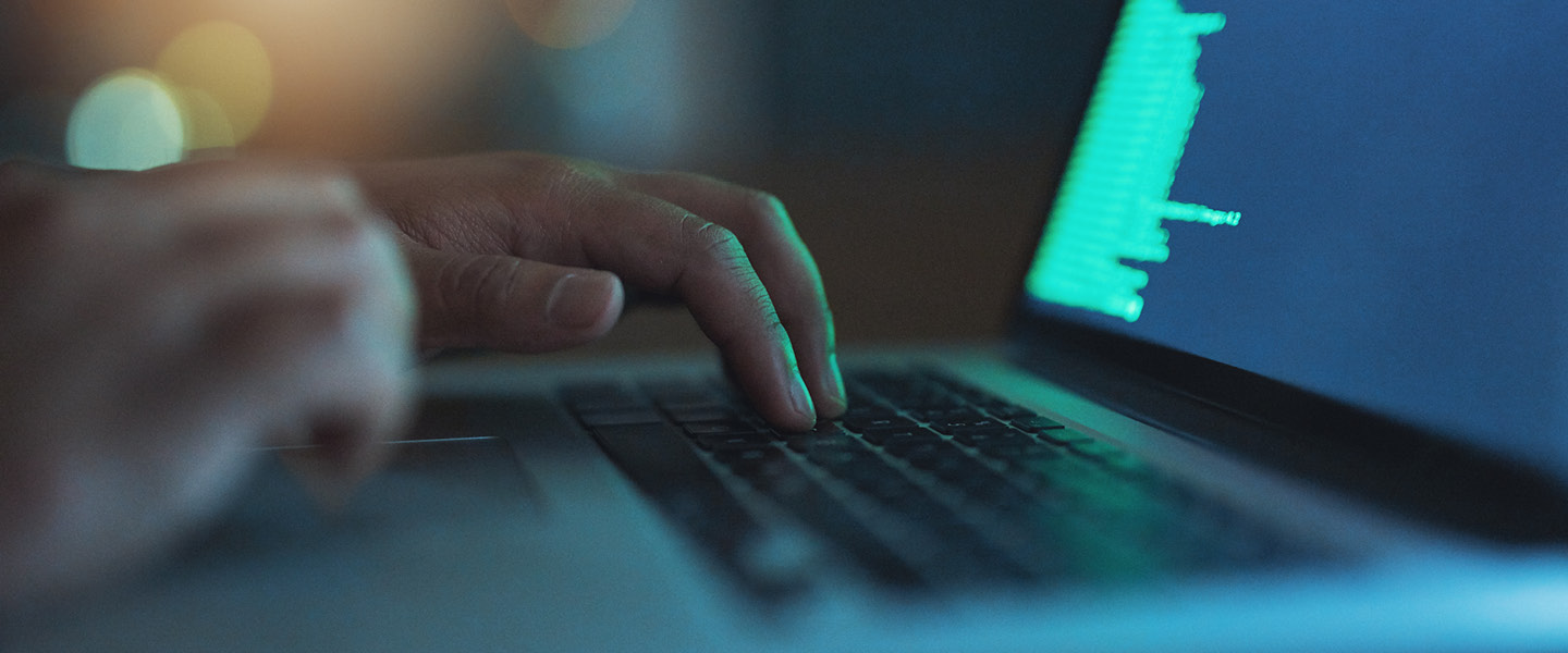 hands typing on a laptop 